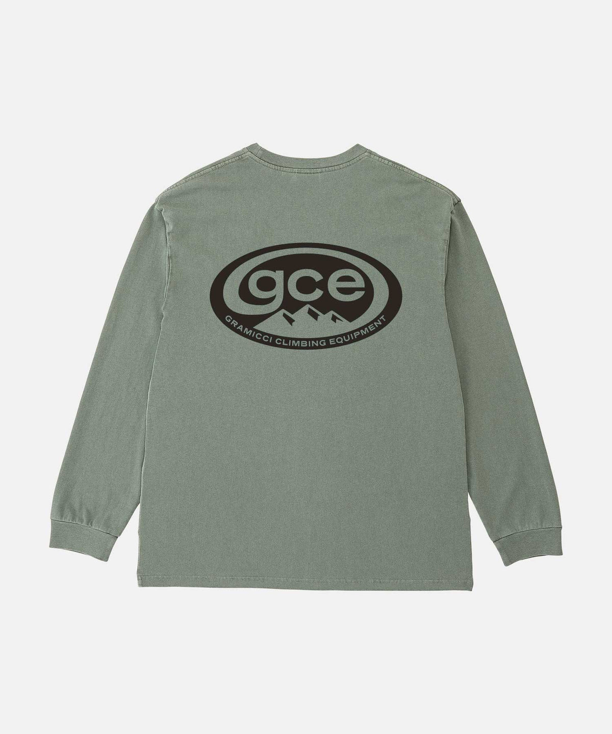 Back view of a Gramicci sage pigment colored GCE Long Sleeve Tee Pigment Dyed with a graphic against a light-tone background.