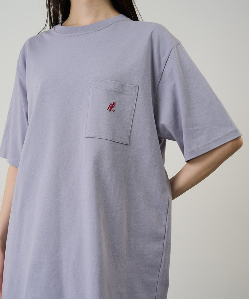 Model wearing a Gramicci lavender One Point Tee with a small running man graphic against a light-tone background.