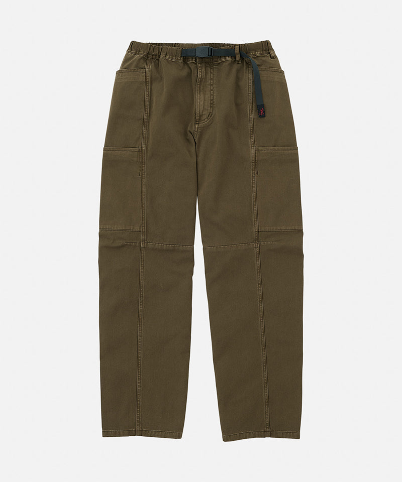 Bark pigment colored Gramicci Voyager Pants with a belt against a light-tone background.
