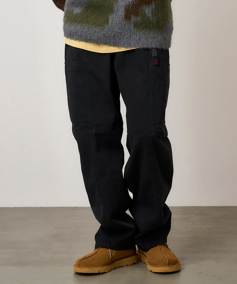 Model wearing black Gramicci Voyager Pants and a mohair sweater on a light-tone background.