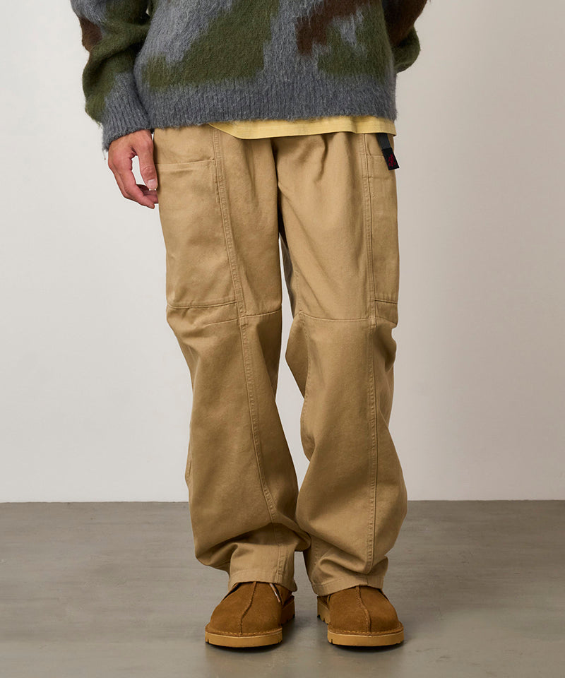 Model wearing chino colored Gramicci Voyager Pants and a mohair sweater on a light-tone background.