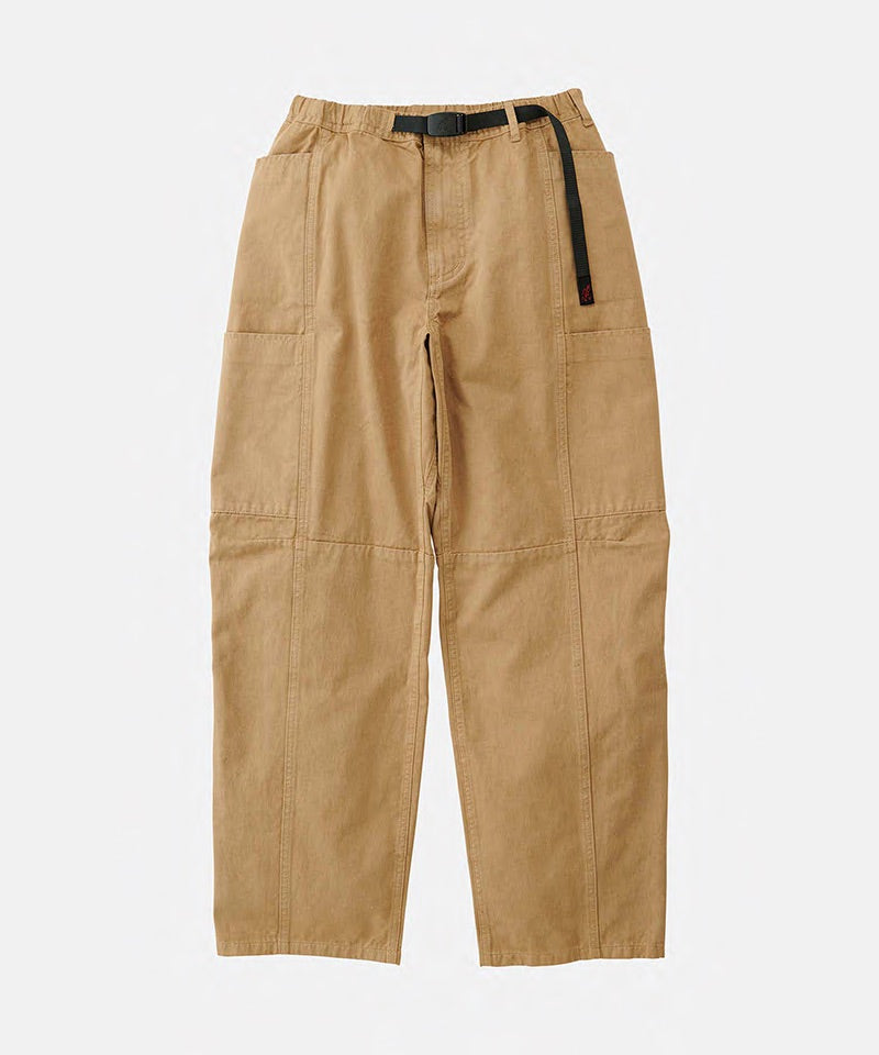 Chino colored Gramicci Voyager Pants with a belt against a light-tone background.