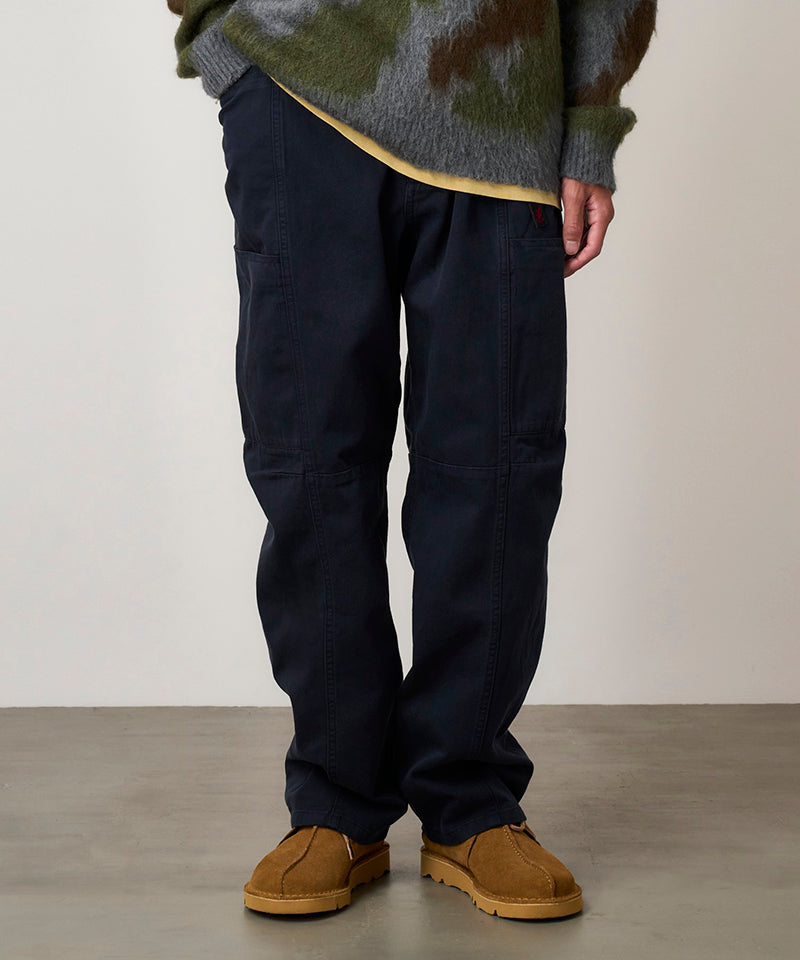 Model wearing double navy Gramicci Voyager Pants and a mohair sweater on a light-tone background.