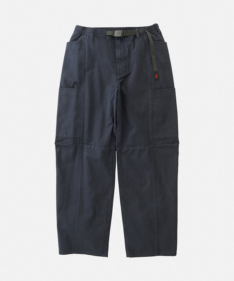 Double navy Gramicci Voyager Pants with a belt against a light-tone background.