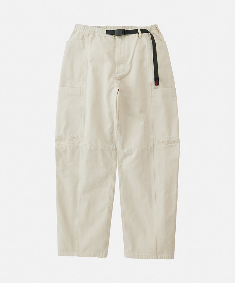 Greige colored Gramicci Voyager Pants with a belt against a light-tone background.