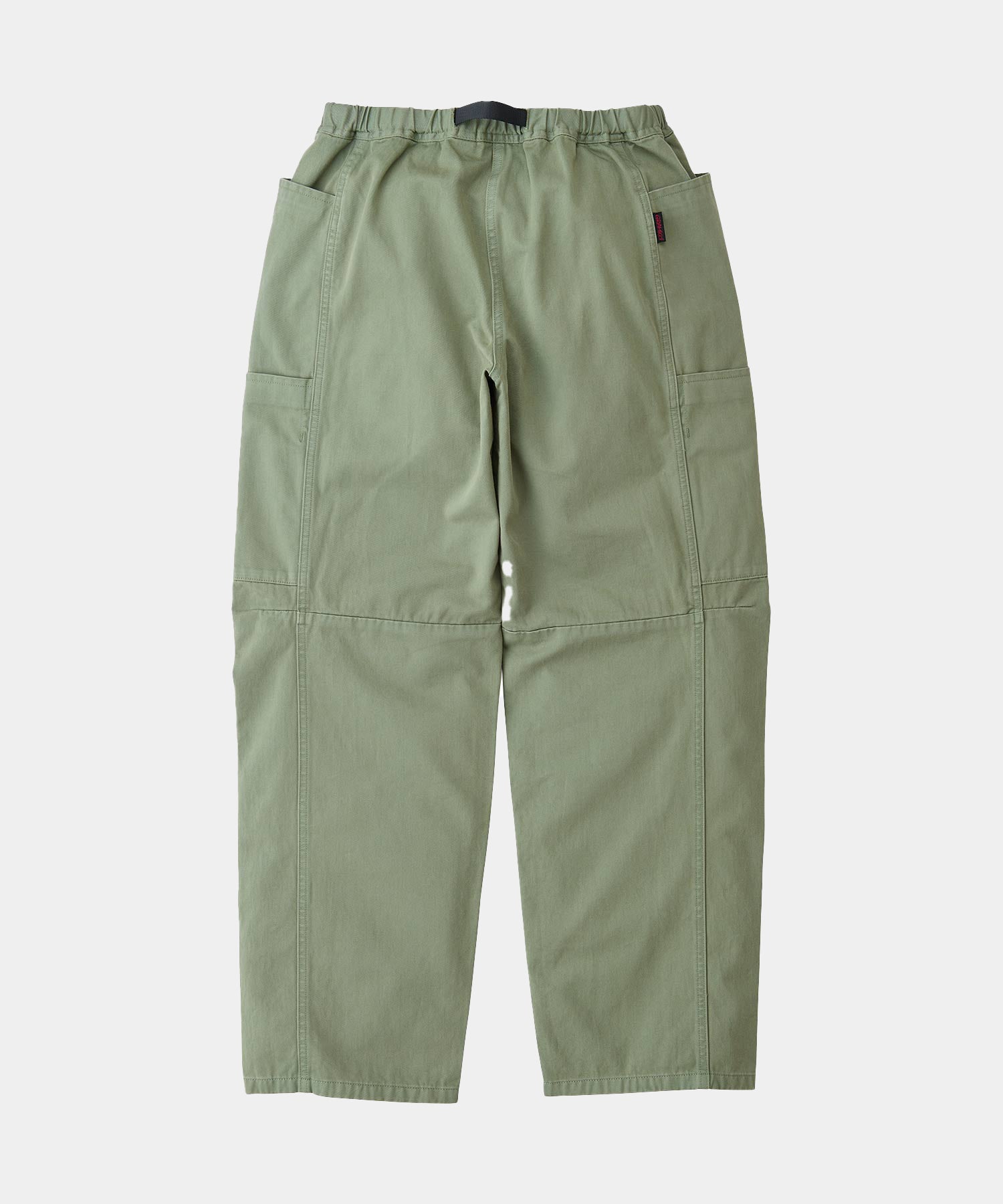 Back view of sage colored Gramicci Voyager Pants on a light-tone background.