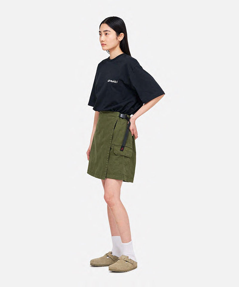 Model wearing a Gramicci G-Skort in the color olive and a black shirt on a light-tone background.