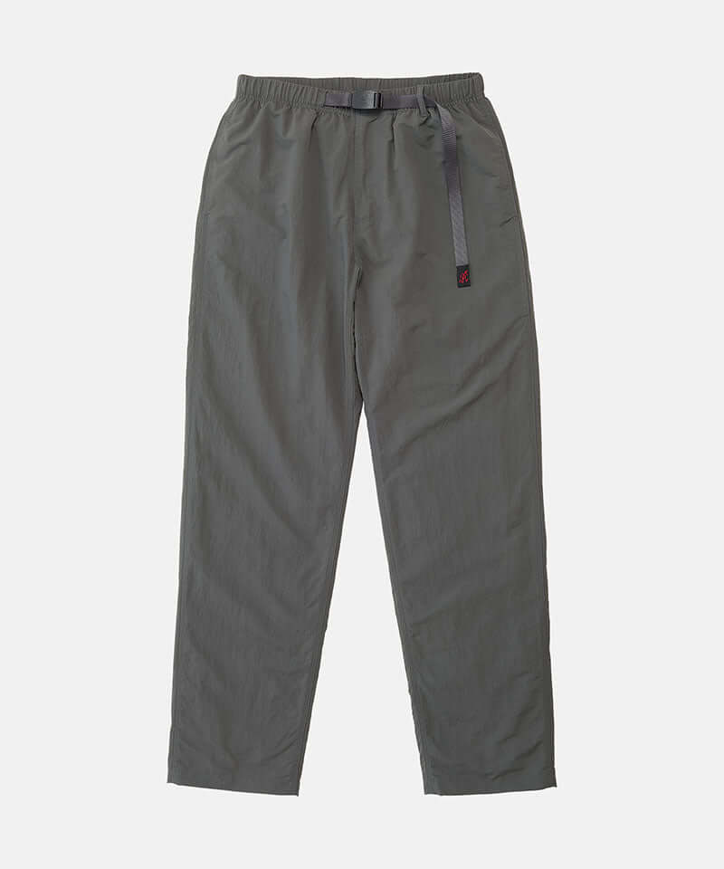 Carbon colored Nylon Gramicci Pants with a belt against a light-tone background.