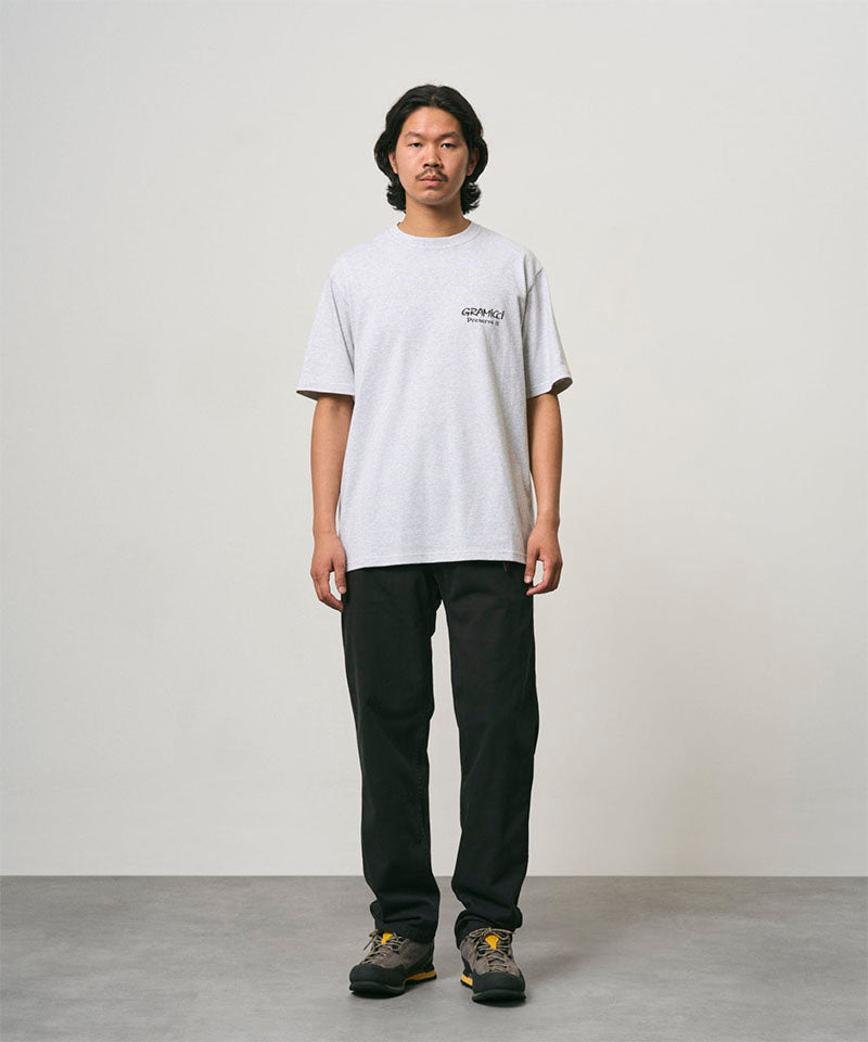 Back view of a Gramicci ash heather Earth Tee with a graphic against a light-tone background.