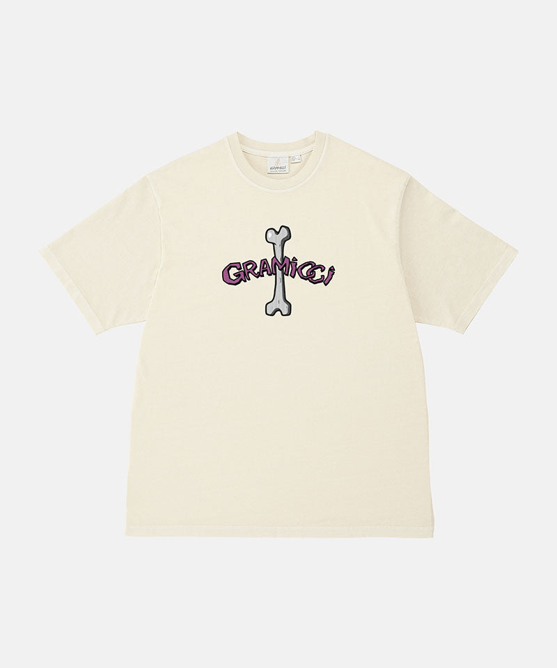 Gramicci natural pigment colored Bone Tee Pigment Dyed with a graphic against a light-tone background.