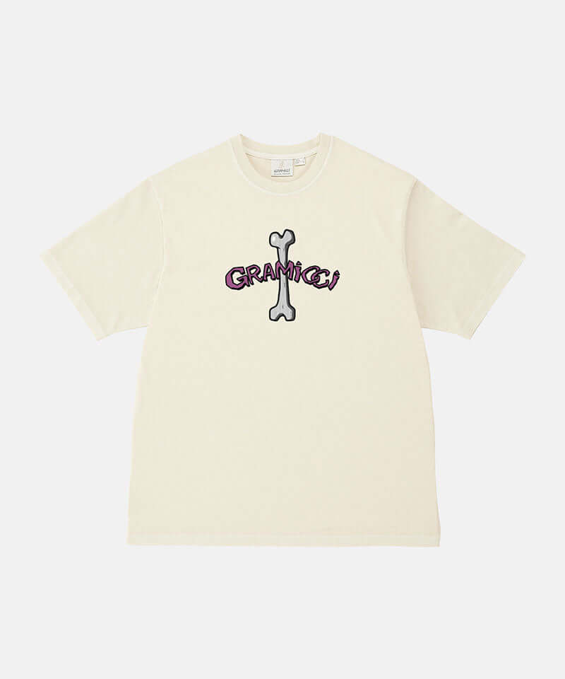 Gramicci natural pigment colored Bone Tee Pigment Dyed with a graphic against a light-tone background.
