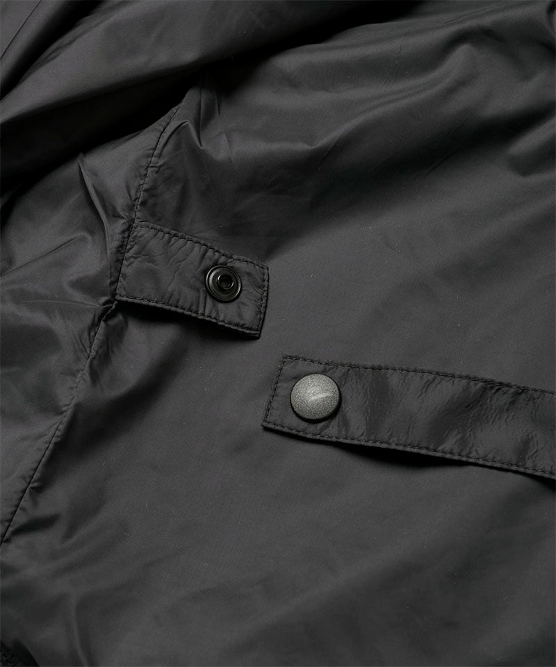 Close-up view of a black Gramicci Thermal Fleece Skirt against a light-tone background.