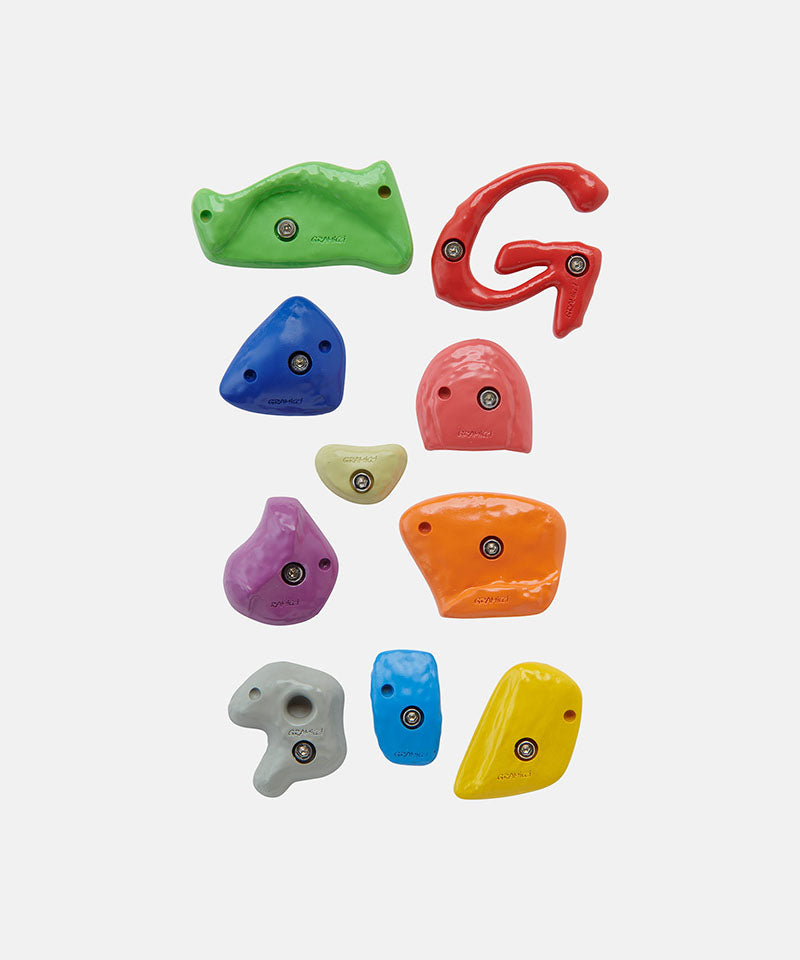 Set of colorful Gramicci climbing hold magnets on a white background