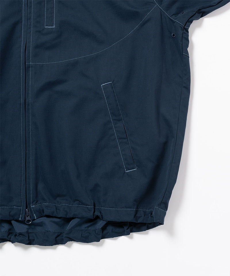 Close-up of a dark navy Gramicci Milton Hooded Jacket on a light-tone background.