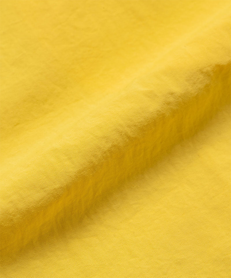Banana colored colored Gramicci Nylon Block Shorts fabric swatch.