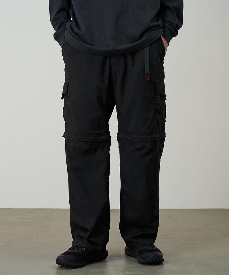 Model wearing black Gramicci Convertible Cargo Pants and a black shirt on a light-tone background.