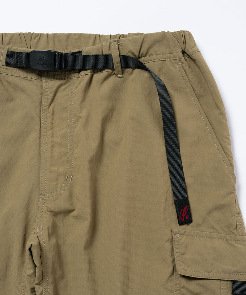 Close-up view of khaki Gramicci Convertible Cargo Pants on a light-tone background.
