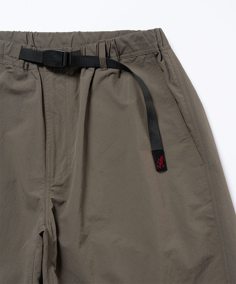 Close-up view of granite colored Gramicci Nylon Paneled Trek Pants on a light-tone background.