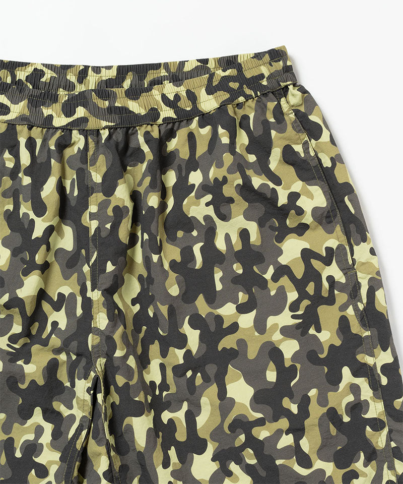 Close-up of the waistband on a olive camo Gramicci Nylon Reef Shorts on a light-tone background.