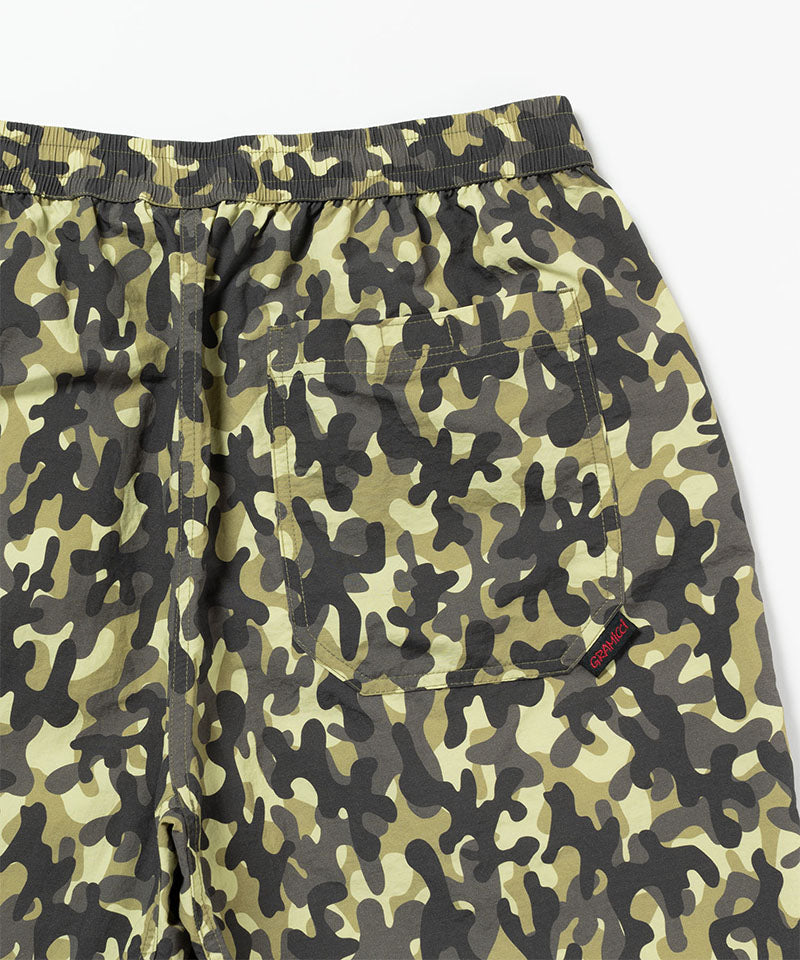 Back view of the Gramicci Nylon Reef Shorts in olive camo featuring a pocket with velcro closure on a light-tone background.