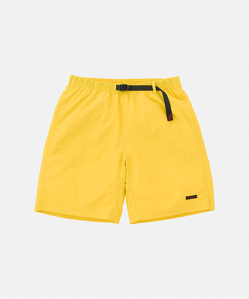 Banana colored Gramicci Nylon Packable G-Shorts with a belt against a light-tone background.