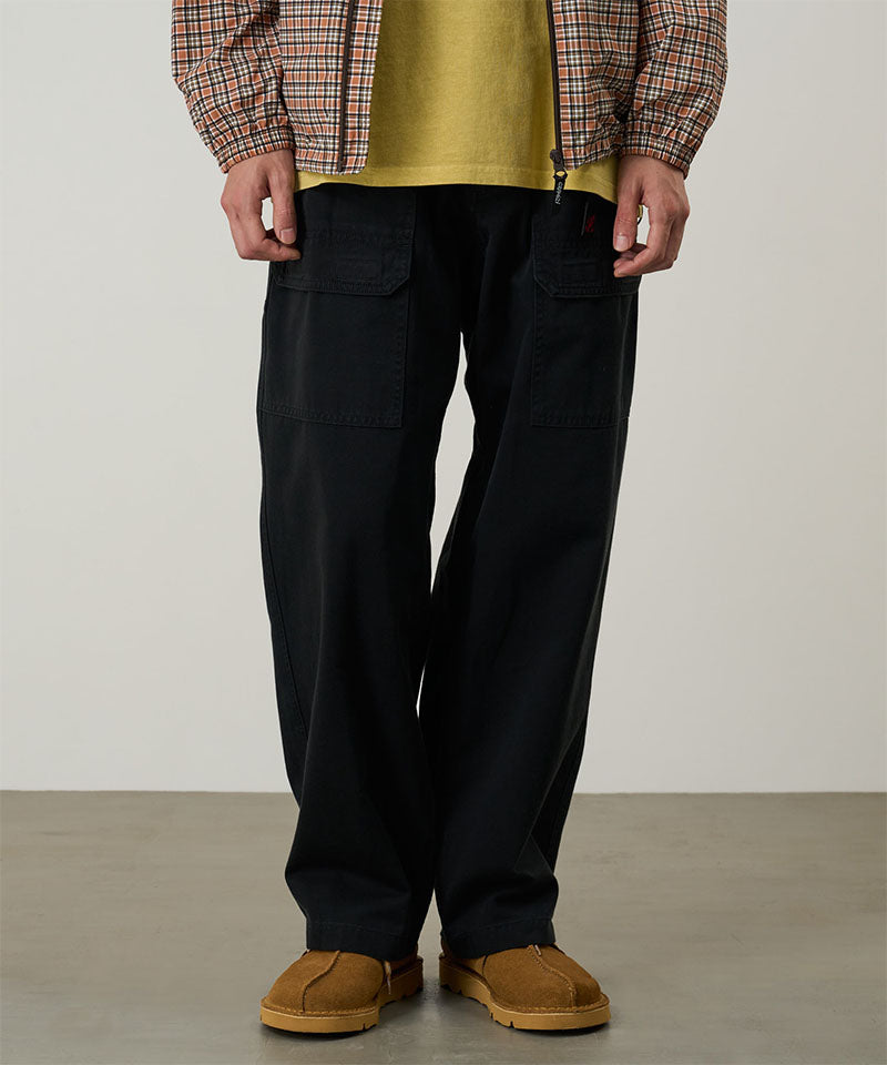 Model wearing black Gramicci EQT Pant and a plaid jacket on a light-tone background.