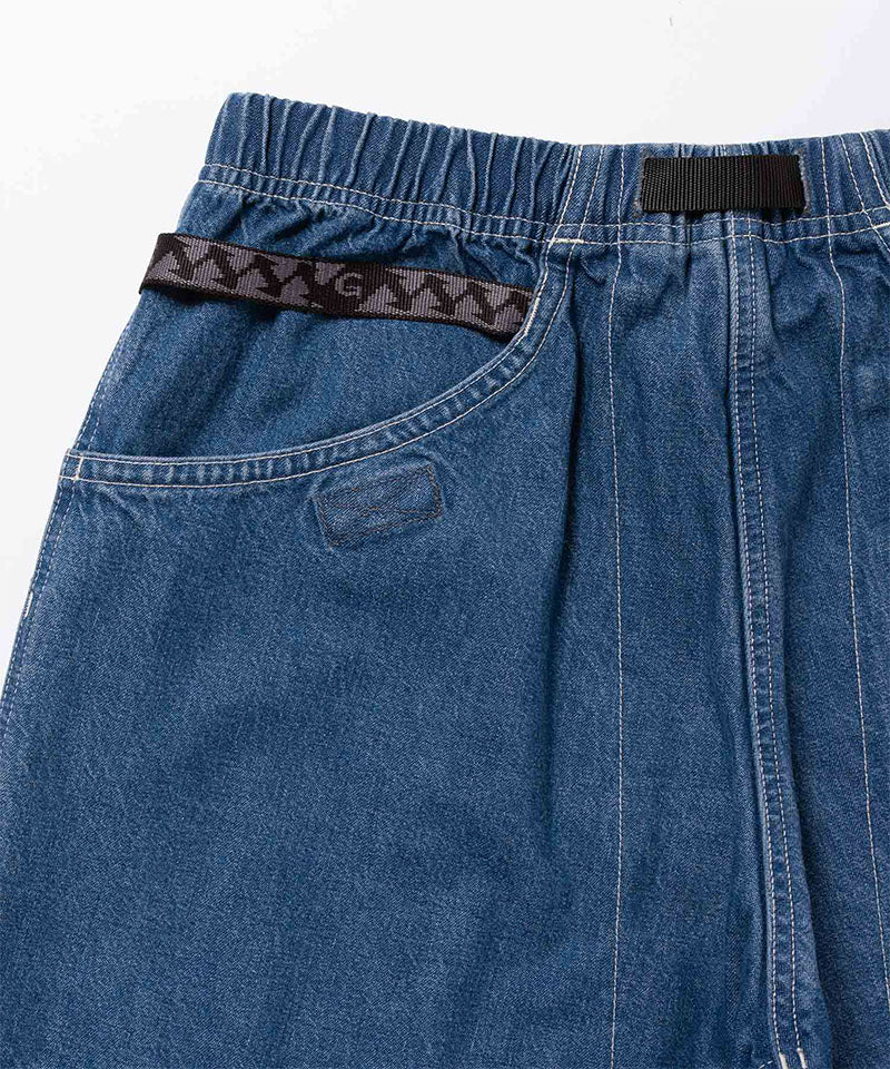 Back view of light wash colored Gramicci Denim EQT Pant on a light-tone background.