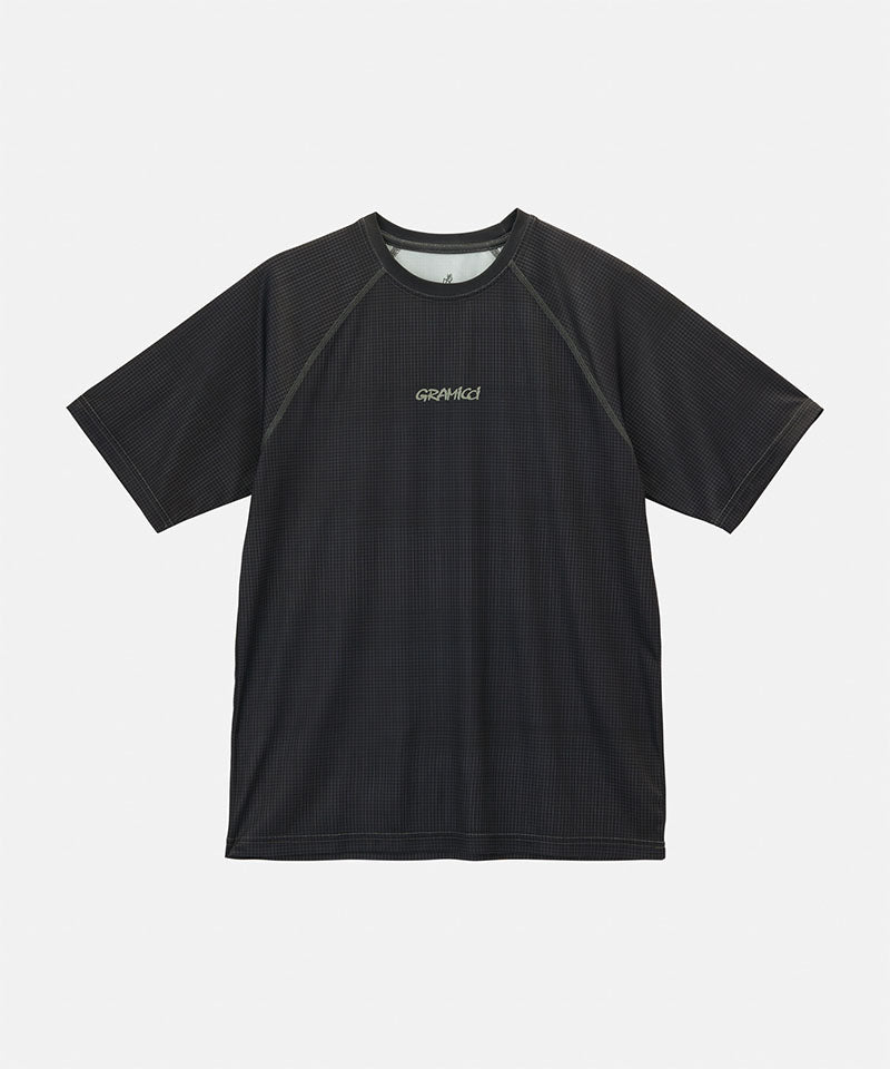 Gramicci black checkered UPF Shield S/S Top with a grey Gramicci graphic against a light-tone background.