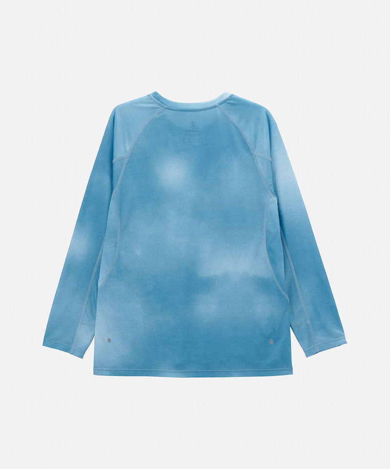 Back view of a Gramicci blue tie-dye L/S 1st Layer shirt with grey graphic against a light-tone background.