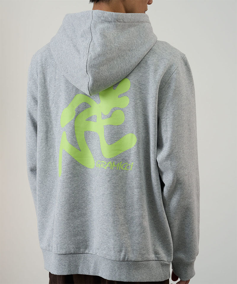 Back view of a model wearing a Gramicci heather grey Running Man Hooded Sweatshirt with bright lime running man graphic against a light tone background.