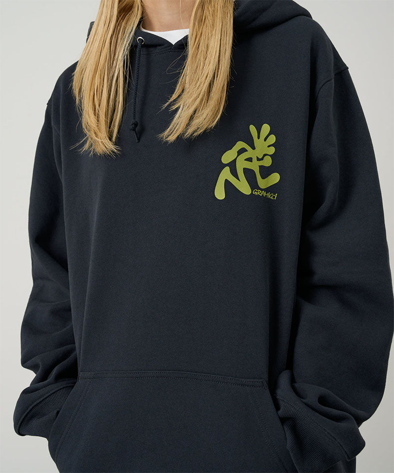 Model wearing a Gramicci vintage black Running Man Hooded Sweatshirt with lime green running man graphic against a light tone background.