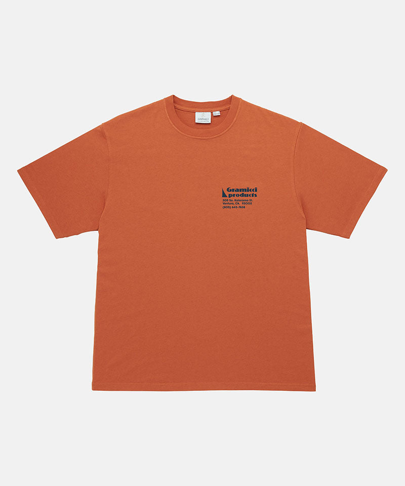Gramicci orange G-Sail Tee with black graphic against a light-tone background.