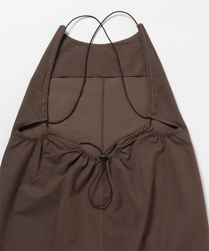 Back view of a Gramicci Women's Woven Milton Dress in the color walnut on a light-tone background.