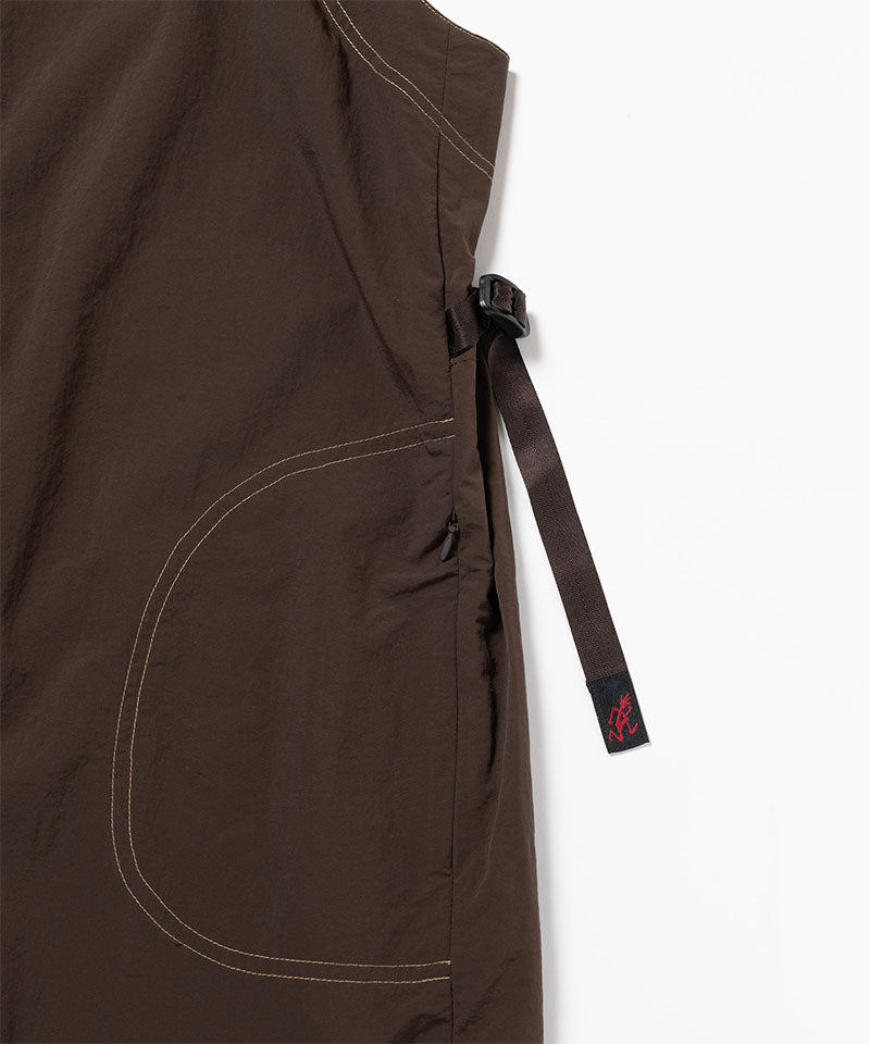 Close-up view of a chocolate colored Gramicci Nylon Dress against a light-tone background.