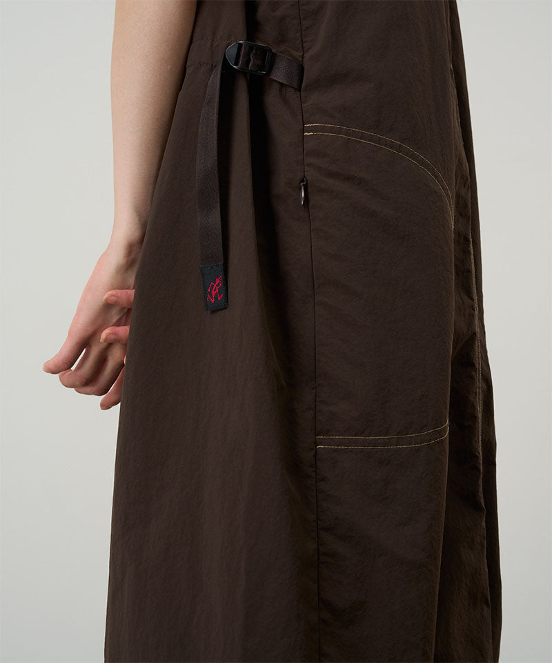 Model wearing a chocolate colored Gramicci Nylon Dress on a light-tone background.
