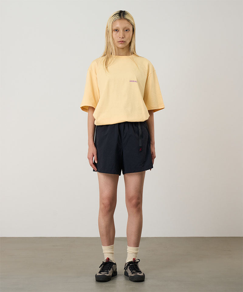 Model wearing black Gramicci Women's Nylon Active Short and a yellow shirt on a light-tone background.