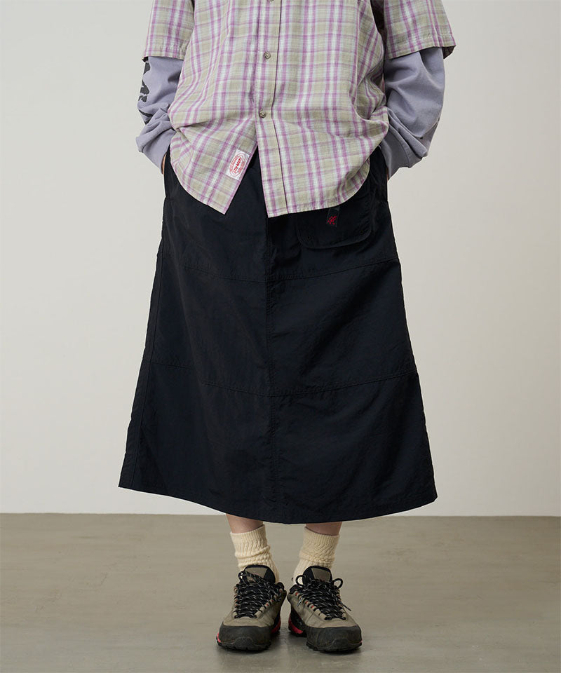 Model wearing a Gramicci black Nylon Utility Skirt against a light-tone background.