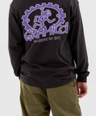 Back view of a model wearing olive green Gramicci Pants and a Gramicci Dirt Long-Sleeve-Tee on a light-tone background.