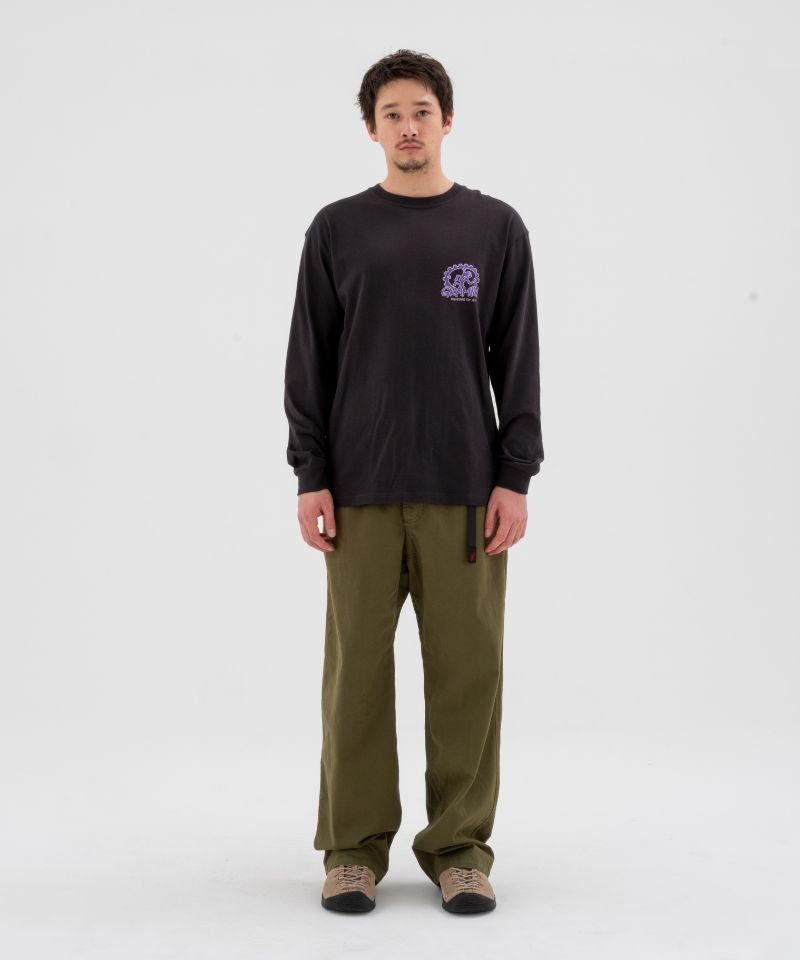 Model wearing olive green Gramicci Pants and a Gramicci Dirt Long-Sleeve-Tee on a light-tone background.