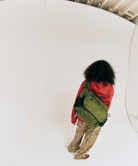 Back view of a model wearing olive Gamicci Messenger Bag and a orange hoodie on a light-tone background.