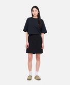 Model wearing a Gramicci G-Skort in the color black and a black shirt on a light-tone background.