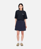 Model wearing a Gramicci G-Skort in the color double navy and a black shirt on a light-tone background.
