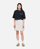 Model wearing a Gramicci G-Skort in the color dune grey and a black shirt on a light-tone background.