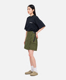 Model wearing a Gramicci G-Skort in the color olive and a black shirt on a light-tone background.
