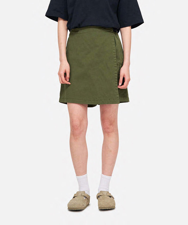 Model wearing a Gramicci G-Skort in the color olive and a black shirt on a light-tone background.