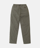 Back view of burnt olive colored Nylon Gramicci Pants on a light-tone background.