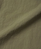 Burnt olive colored colored Nylon Gramicci Pants fabric swatch.