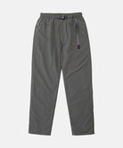 Carbon colored Nylon Gramicci Pants with a belt against a light-tone background.