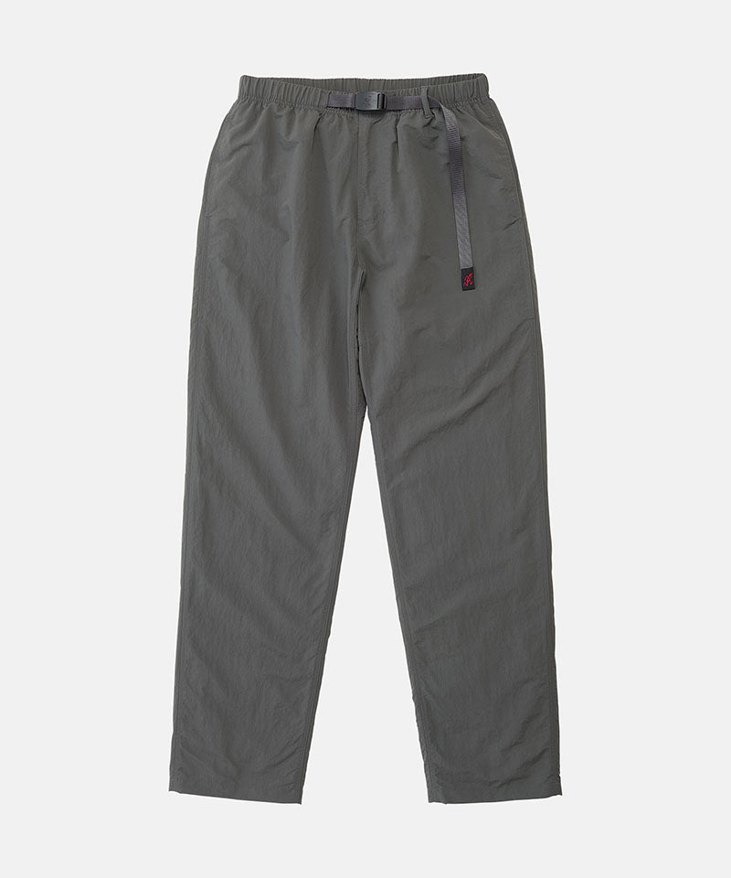 Carbon colored Nylon Gramicci Pants with a belt against a light-tone background.