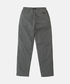 Back view of carbon colored Nylon Gramicci Pants on a light-tone background.